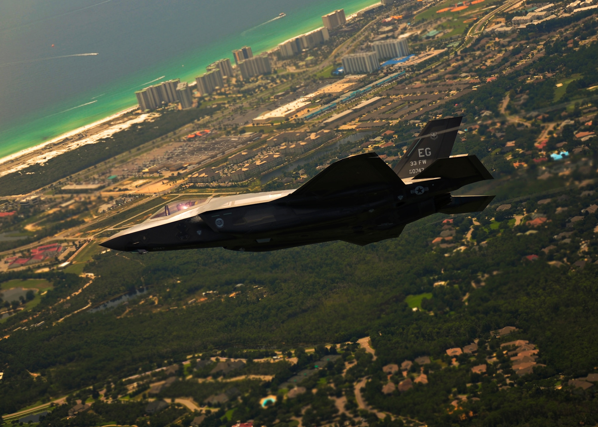 DOD’s first F-35 Lightning II joint strike fighter soars over the Northwest Florida airspace before landing at its new home at Eglin Air Force Base, July 14.  Its pilot, Lt. Col. Eric Smith, of the 58th Fighter Squadron, is the first Air Force qualified JSF pilot.  (U.S. Air Force photo/Staff Sgt. Joely Santiago)
