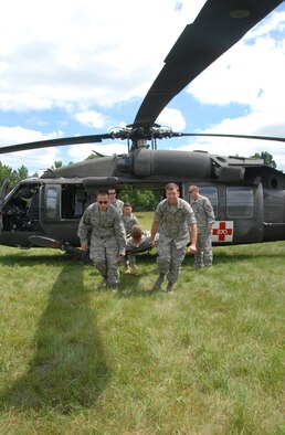 Members of the 178th Medical Group, Springfield, Ohio, practice a hot unload of a medical evacuation patient from a UH-60 Black Hawk July 13 during the domestic operations portion of the 2011 Patriot Exercise at Volk Field Combat Readiness Training Center, Wis. During the exercise, the 178 MDG received training from Army personnel on the proper procedures for loading and unloading medical evacuation patients. (U.S. Air Force photo by Senior Airman Amy N. Adducchio/Released)