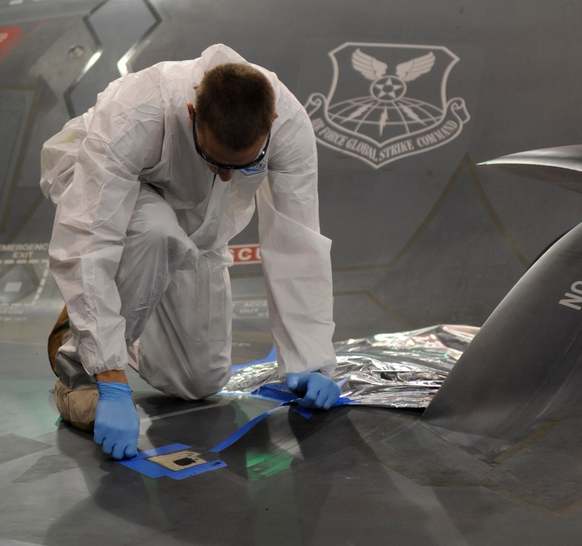 WHITEMAN AIR FORCE BASE, Mo. ? Senior Airman Kyle Miller, 509th Maintenance Squadron B-2 Spirit LO structural maintenance technician, repairs the external coating on the B-2 here July 8. (U.S. Air Force photo by Senior Airman Alexandra M. Boutte) (RELEASED)