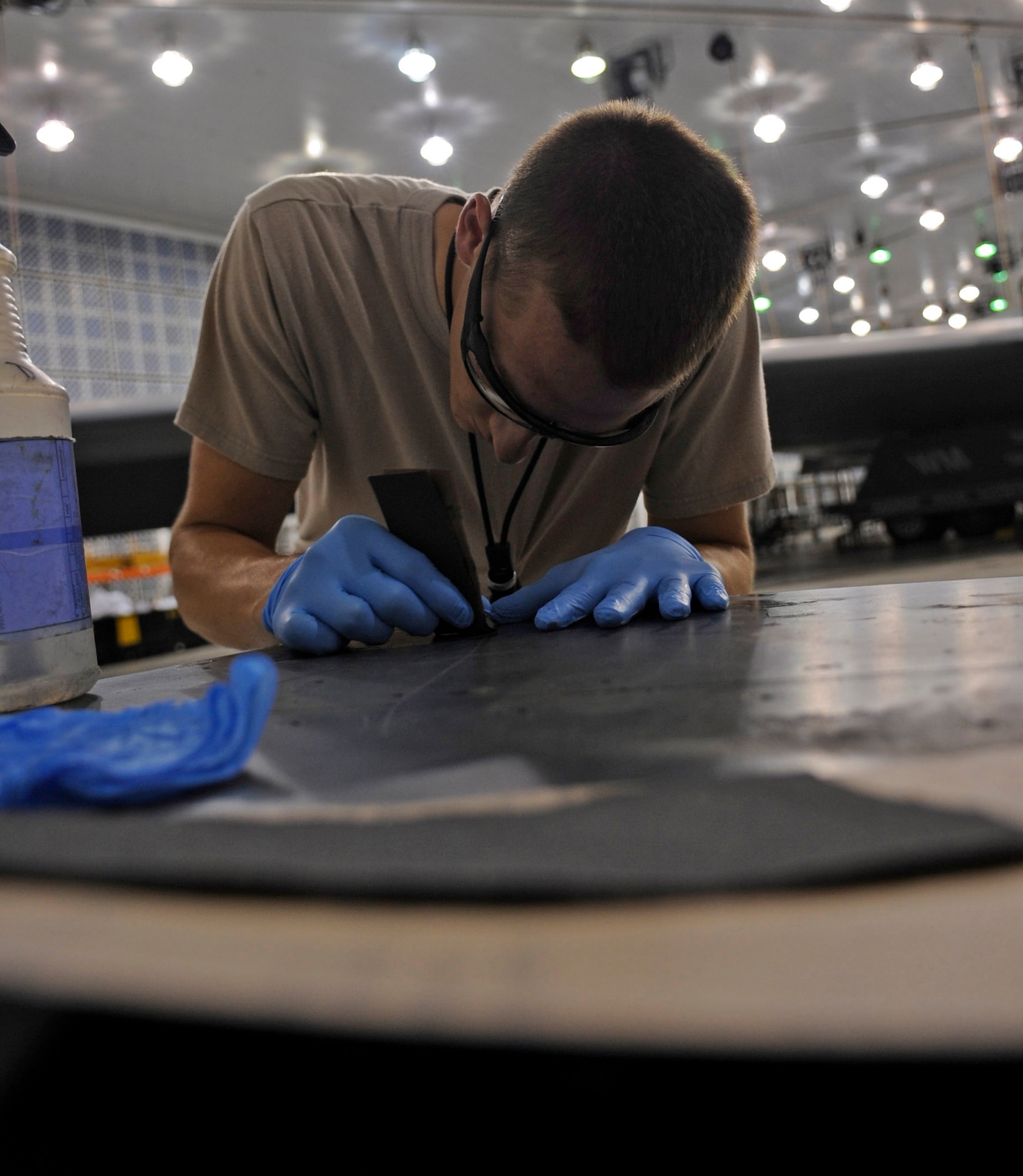 WHITEMAN AIR FORCE BASE, Mo. ? Senior Airman Kyle Miller, 509th Maintenance Squadron B-2 Spirit LO structural maintenance technician, removes the coating on the B-2 here July 8. The LO characteristics of the B-2 are a means of defense this aircraft has during combat missions. (U.S. Air Force photo by Senior Airman Alexandra M. Boutte) (RELEASED)