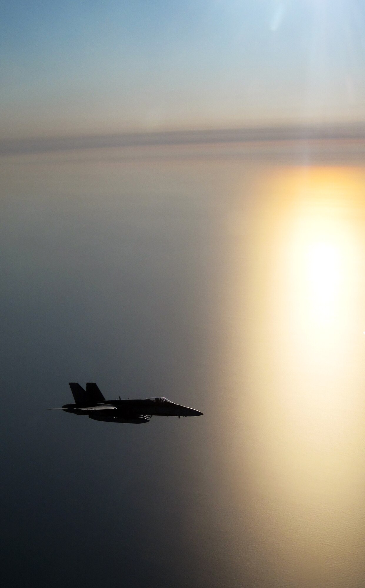 RAF MILDENHALL, England – A Canadian CF-18 Hornet flies alongside a KC-135 Stratotanker, from the 100th Air Refueling Wing, over the Mediterranean Sea July 14, 2011. The Hornet was waiting to receive fuel in order to continue its support of NATO-led Operation Unified Protector. Since March 23, 2011, the 100th ARW has supported NATO allies by off loading more than 40 million pounds of fuel to more than 4,000 receivers. (U.S. Air Force photo/Senior Airman Rachel Waller) 
