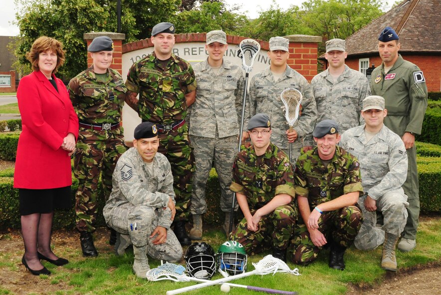 RAF MILDENHALL, England -- British and American members of the RAF Marham lacrosse team pose for a photo with Col. Christopher Kulas, 100th Air Refueling Wing commander (right), and Sheila Bailey, British-American Council chairman (left), after each member was presented a special coin as an award from the B-AC. The coin is awarded on behalf of the B-AC to groups or individuals, both British and American, from on or off base, and epitomizes the special relationship shared by the United Kingdom and the United States. It is a way to recognize efforts both on a local and very personal level. (U.S. Air Force photo/Karen Abeyasekere)