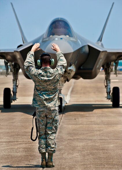 Tech. Sgt. Brian West, of the 33rd Aircraft Maintenance Squadron, marshals in DOD's newest aircraft, the F-35 Lightning II joint strike fighter to a stop at its new home at Eglin Air Force Base, Fla., July 14.  West is the crew chief for the first F-35.  (U.S. Air Force photo/Samuel King Jr.) 




