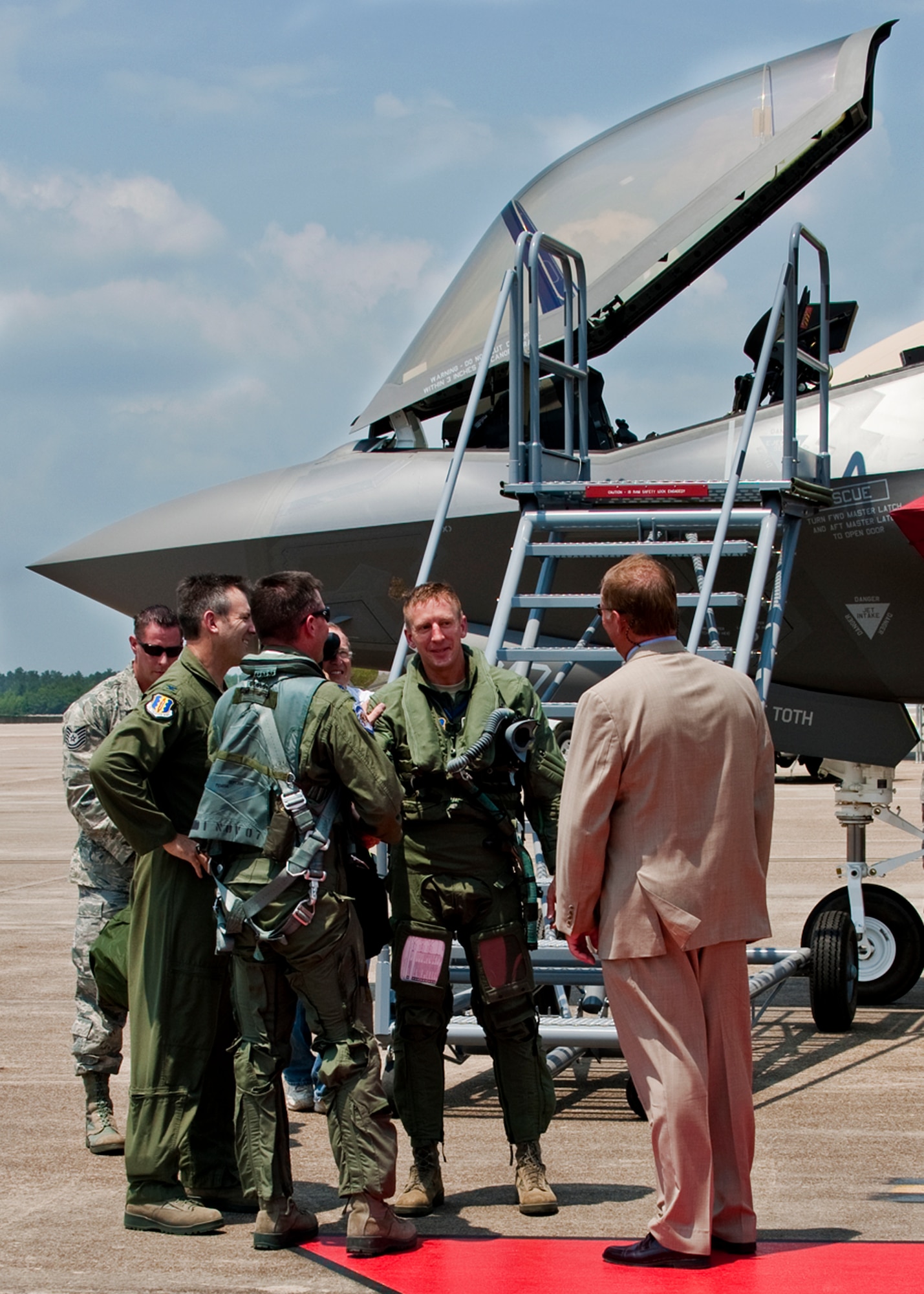 Lt. Col. Eric Smith, of the 58th Fighter Squadron, talks with his squadron and wing commanders after piloting the first F-35 Lightning II joint strike fighter to its new home at Eglin Air Force Base, Fla., July 14. (U.S. Air Force photo/Samuel King Jr.)

