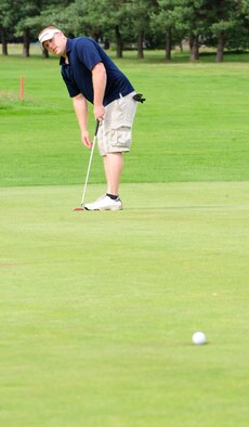 RAF MILDENHALL, England -- Brian Szarek, 100th Maintenance Squadron, sinks a 40-foot birdie putt on the 10th green during the RAF Mildenhall Intramural Golf play-offs at Breckland Pines Golf Club, RAF Lakenheath, July 12, 2011. The putt gave his team the lead against the 100th Communications Squadron at the start of the back nine and they were already one up after eight holes of the front nine. (U.S. Air Force photo/Senior Airman Ethan Morgan)