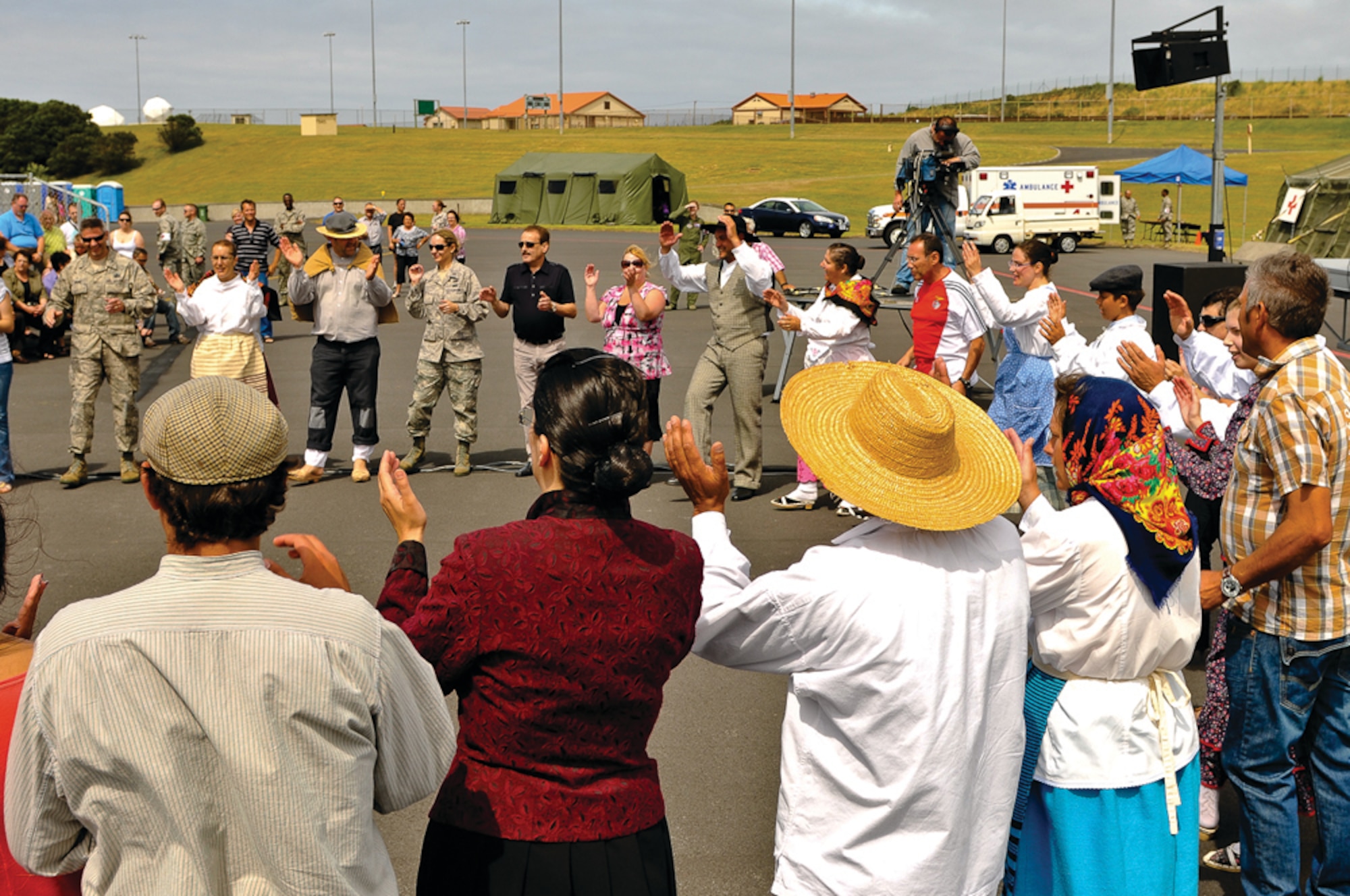 Members of the “Cantares da Eira,” a local folklore band from Vila das Lajes, dance with members of the 65th Air Base Wing and  local nationals in a traditional song, called “Balancé,” during the open house July 10, 2011.  (Photo by Lucas Silva)