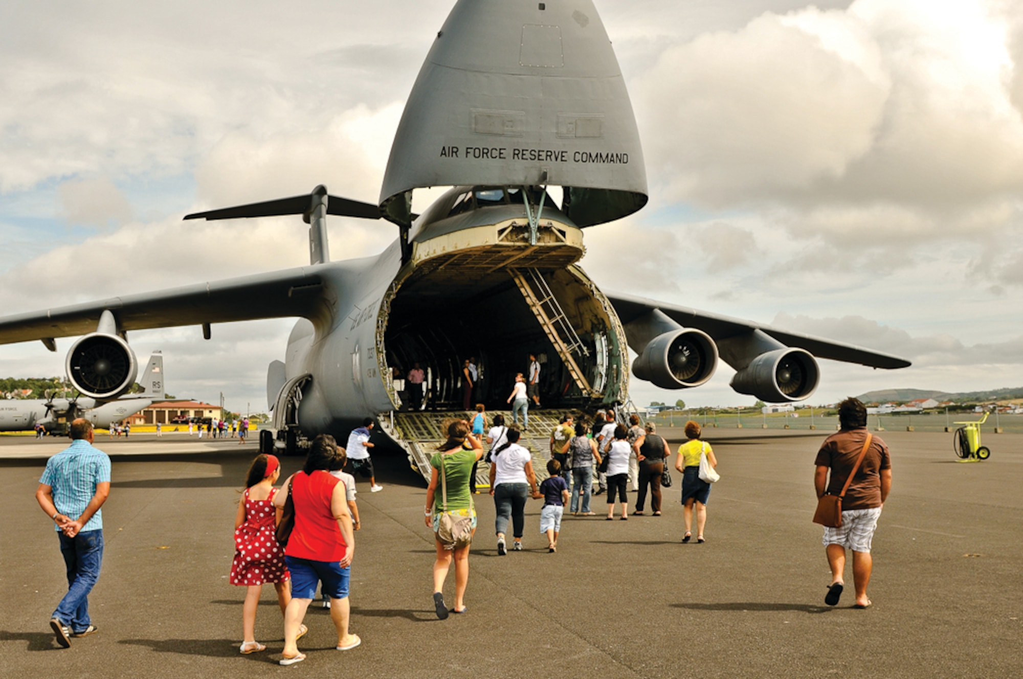Members of the local Portuguese Community enter a C-5 for a tour of the interior of the aircraft during the open house Day held here July 10, 2011.  The event also coincided with the Portuguese air force's 59th anniversary.  (Photo by Lucas Silva)