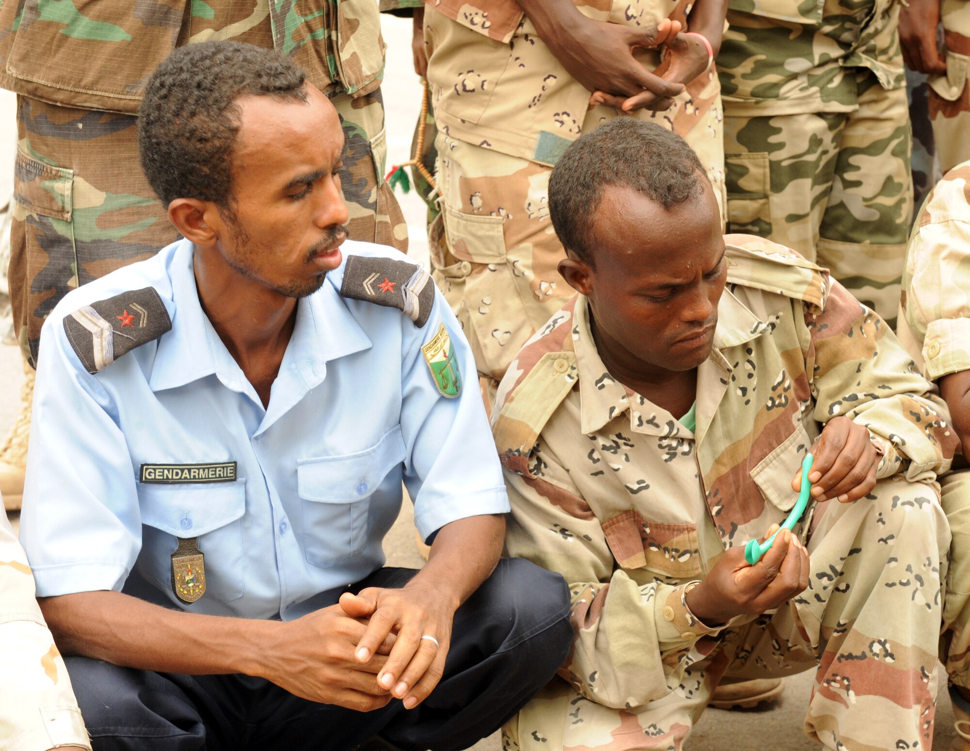 DJIBOUTI CITY, Djibouti - Two Djiboutian soldiers examine a nasopharyngeal tube used to assist an injured person with breathing during a week-long medical seminar, July 7.  Djiboutian soldiers attended this seminar with their U.S. counterparts to share information on providing immediate medical care for soldiers, whether at home or in a remote environment. (U.S. Air Force photo by Master Sgt. Ray Bowden)
