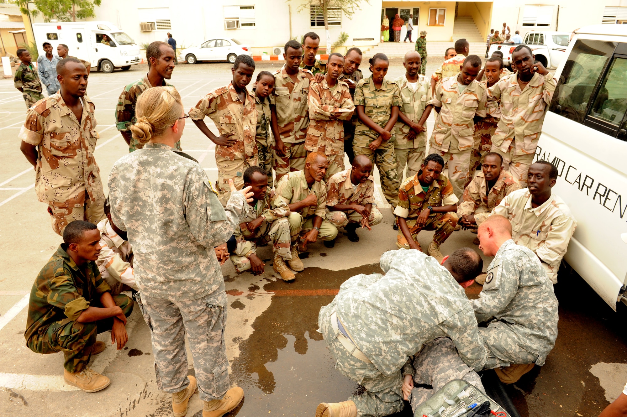 DJIBOUTI CITY, Djibouti - Combined Joint Task Force-Horn of Africa medical professionals demonstrate how to treat and load an injured soldier onto a litter during a week-long medical seminar, July 7. U.S. servicemembers shared their procedures for providing immediate care and treatment of injured soldiers whether at home station or in a remote environment with their Djiboutian counterparts. (U.S. Air Force Photo Master Sgt. Ray Bowden)