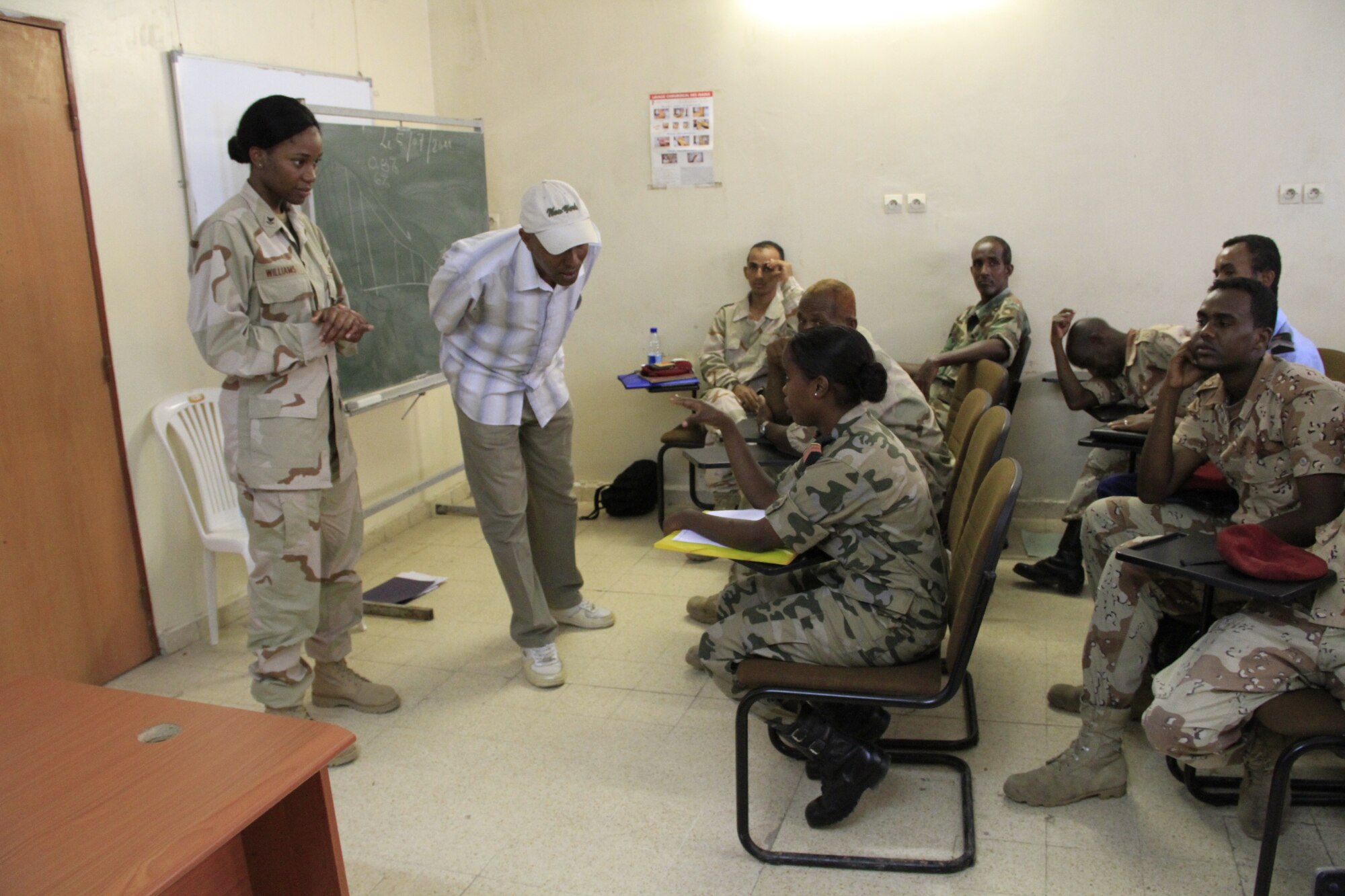 DJIBOUTI CITY, Djibouti - Djibouti Corporal Darojo Daher Bogoreh and U.S. Navy Hospital Corpsman 2nd Class Tiaira Williams discuss her duties as a Combined Joint Task Force-Horn of Africa (CJTF-HOA) corpsman during a week-long Djiboutian - U.S. medical seminar in Djibouti, July 5.  Members from CJTF partnered with the Djiboutian Ministry of Defense Health Services to share medical best practices. This type of information exchange between the two partner nations has occurred annually for nearly a decade. (Air Force photo by Capt. Jennifer Pearson)