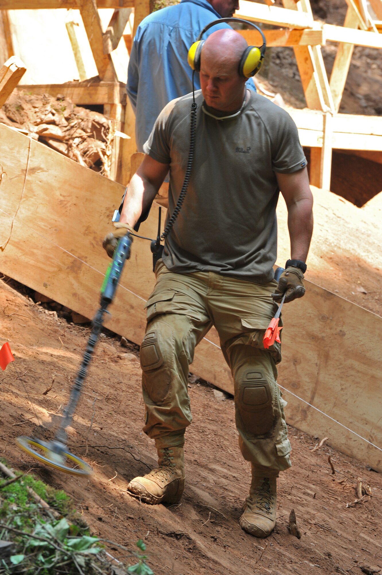 BETTENFELD, Germany – U.S. Marine Corps Sgt. Joey Fierimonte, assigned to the Joint Prisoner of War, Missing in Action Accounting Command, out of Honolulu, scans the ground using a metal detector at an excavation site here July 12. The mission of the JPAC team here is to organize the search and recovery of unaccounted-for American service members from World War II. (U.S. Air Force photo/Airman 1st Class Dillon Davis)