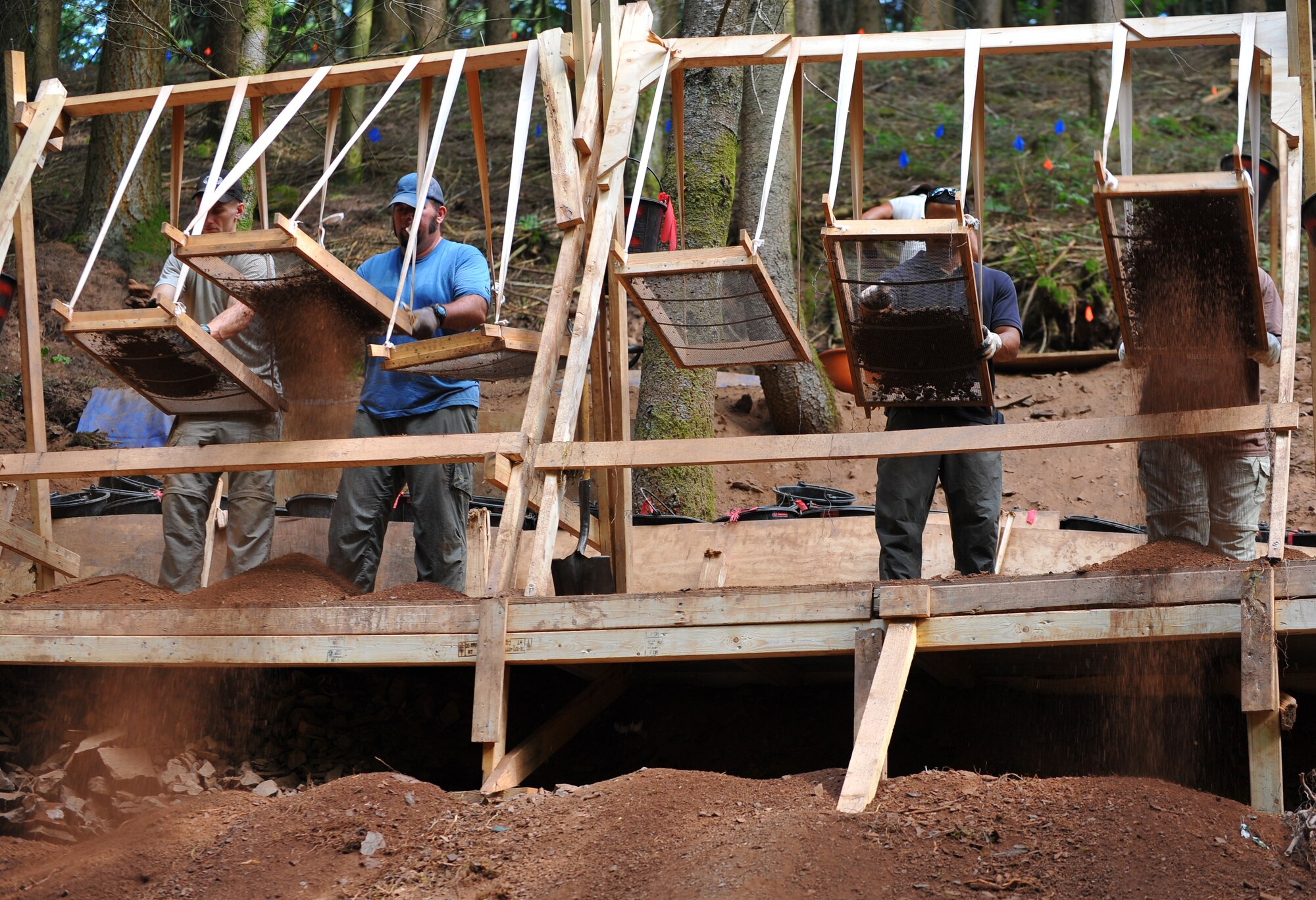 BETTENFELD, Germany – U.S. service members assigned to the Joint Prisoner of War, Missing in Action Accounting Command, out of Honolulu, sift dirt and rock at an excavation site here July 12. The mission of the JPAC team here is to organize the search and recovery of unaccounted-for American service members from World War II. (U.S. Air Force photo/Airman 1st Class Dillon Davis)