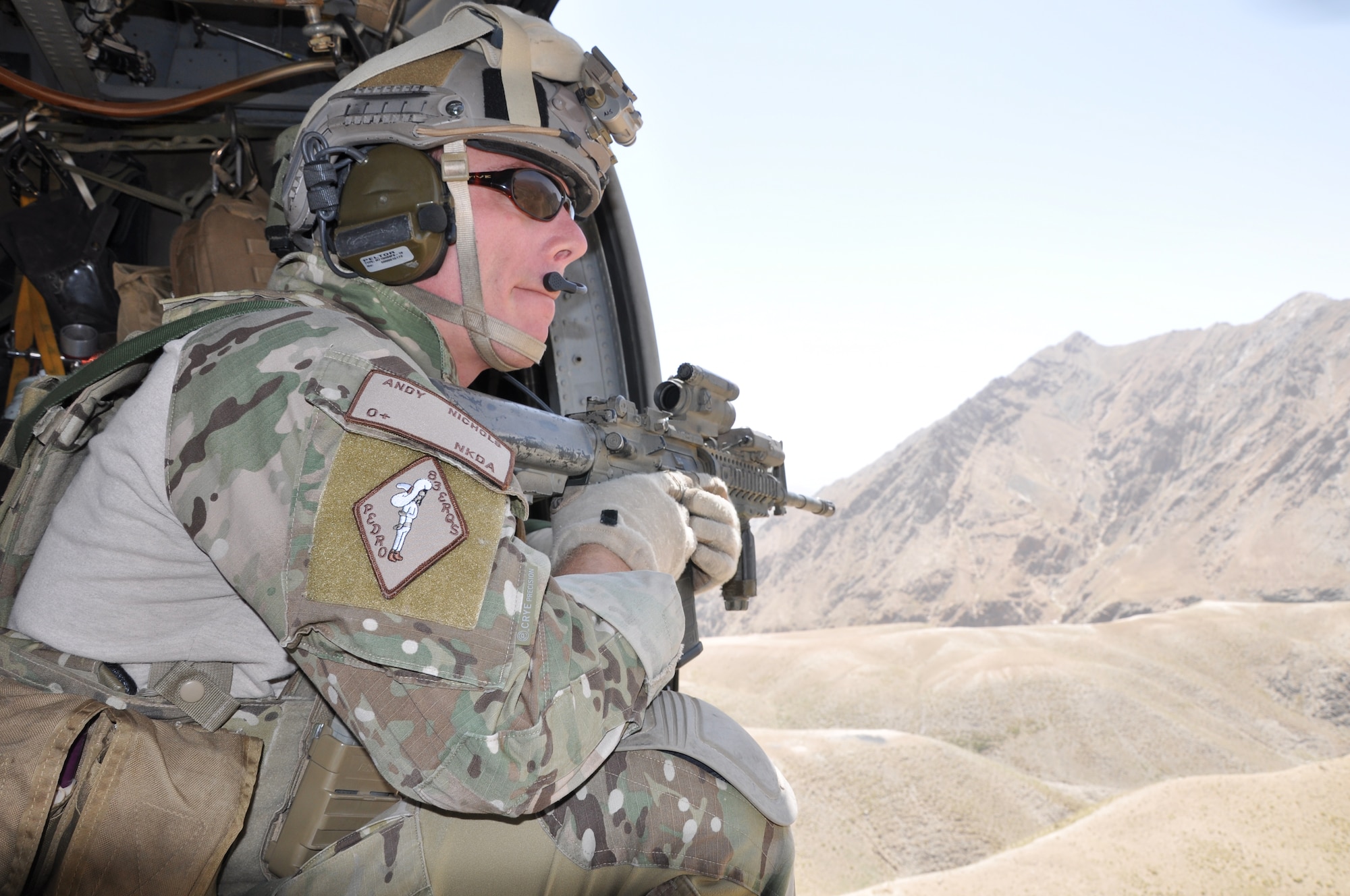 BAGRAM AIRFIELD, Afghanistan -- Senior Airman Andrew Nichols, 83rd Expeditionary Rescue Squadron pararescue jumper, provides security aboard a HH-60G Pave Hawk July 8. Airman Nichols assisted in the rescue of two downed French pilots June 11. (U.S. Air Force photo/Staff Sgt. John Wright)