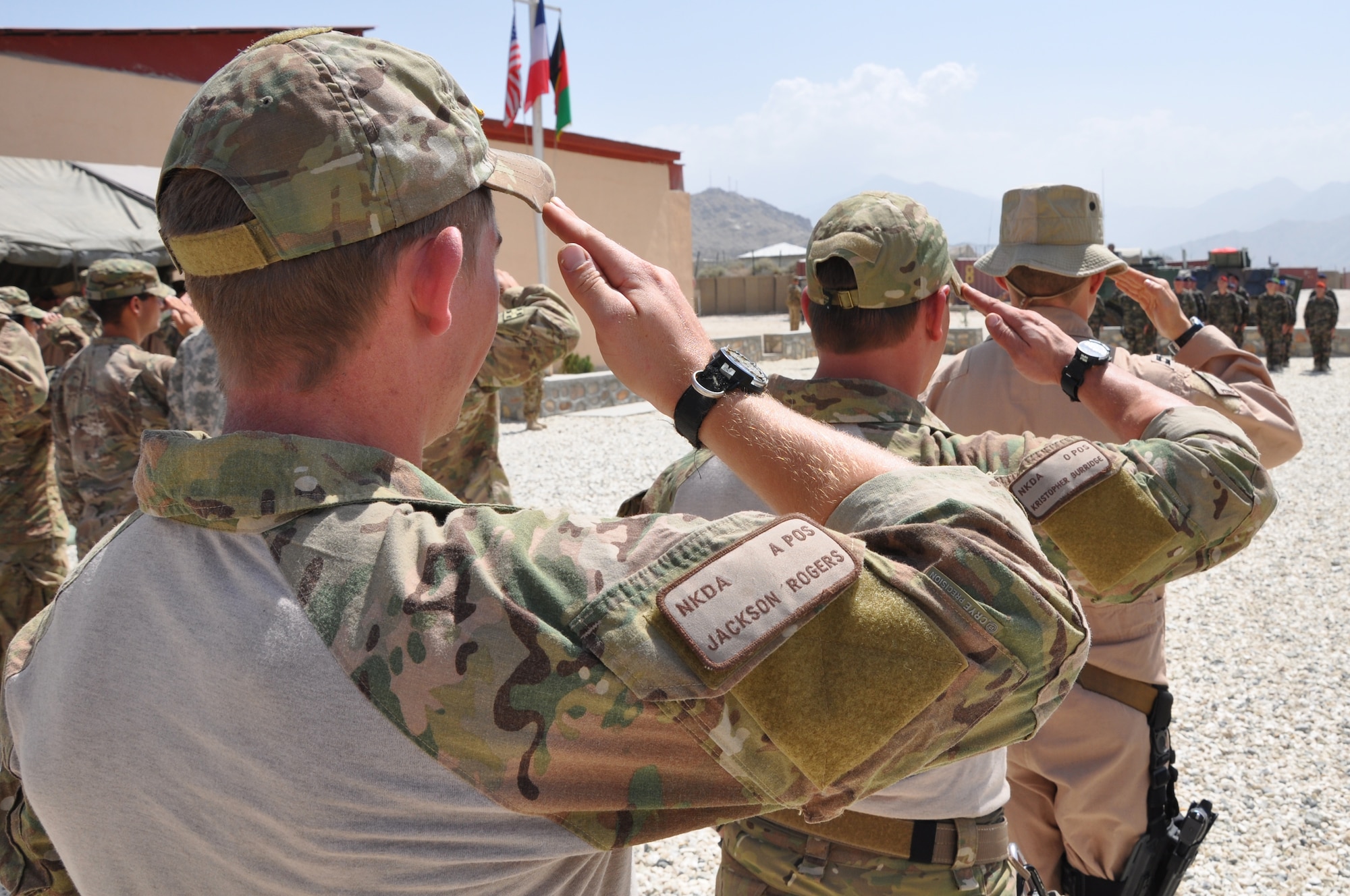 BAGRAM AIRFIELD, Afghanistan -- Senior Airman Jackson Rogers, Tech. Sgt. Kristopher Burridge, both 83rd Expeditionary Rescue Squadron pararescue jumpers, and Capt. John Mosier, 83rd ERQS HH-60G Pave Hawk pilot, present arms after being awarded the French National Defense Gold Medal with bronze star during a ceremony at Forward Operating Base Morales-Frazier July 8. (U.S. Air Force photo/Staff Sgt. John Wright)