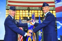 Col. Patrick T. McKenzie, 51st Fighter Wing commander, takes the guidon from to Lt. Gen. Jeffery A. Remington, 7th Air Force commander, during a change of command ceremony . Col. McKenzie previously served at the Pentagon as the Secretary of the Air Force Legislative Liaison Directorate, weapons division chief.  (U.S. Air Force Photos by/ Senior Airman Adam Gant)