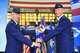Col. Patrick T. McKenzie, 51st Fighter Wing commander, takes the guidon from to Lt. Gen. Jeffery A. Remington, 7th Air Force commander, during a change of command ceremony . Col. McKenzie previously served at the Pentagon as the Secretary of the Air Force Legislative Liaison Directorate, weapons division chief.  (U.S. Air Force Photos by/ Senior Airman Adam Gant)