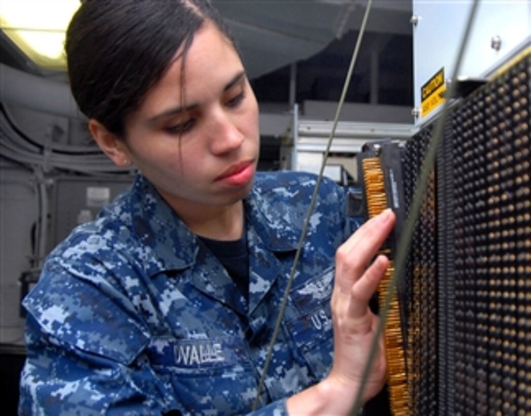 Airman Analia Ovalle troubleshoots a general-purpose interface console aboard the aircraft carrier USS Ronald Reagan (CVN 76) in the Arabian Sea on July 2, 2011.  The Ronald Reagan and Carrier Air Wing 14 are deployed to the U.S. 5th Fleet area of responsibility conducting close-air support missions as part of Operation Enduring Freedom.  