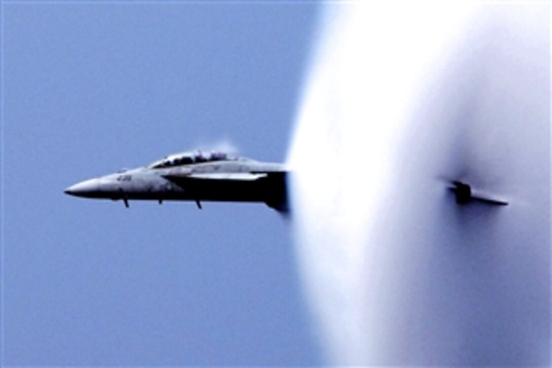 An F/A-18F Super Hornet shakes off a vapor cloud during a flight demonstration aboard the USS Enterprise in the Atlantic Ocean, July 14, 2011. The USS Enterprise embarked 1,500 friends and family on the way to homeport at Naval Station Norfolk after a six-month deployment.