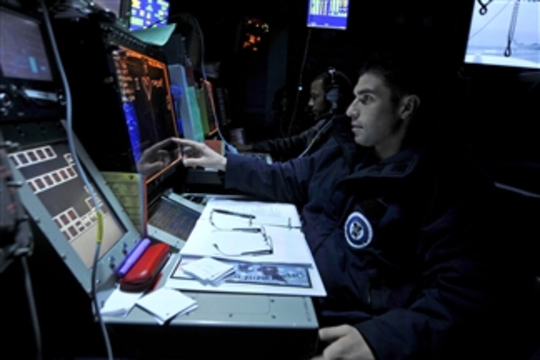 Petty Officer 3rd Class David Gomez tracks aircraft aboard the aircraft carrier USS Ronald Reagan (CVN 76) in the Arabian Sea on July 2, 2011.  The Ronald Reagan and Carrier Air Wing 14 are deployed to the U.S. 5th Fleet area of responsibility conducting close-air support missions as part of Operation Enduring Freedom.  