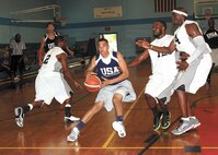 Team USA point guard Andre Harp-Thomas drives between three Metroplex Lightning players during a 118-85 win at the Chaparal Fitness Center. A Judson High School graduate, Harp-Thomas is on the Armed Forces Basketball team representing the U.S. at the CISM World Games in Brazil. (U.S. Air Force photo/Robbin Cresswell)