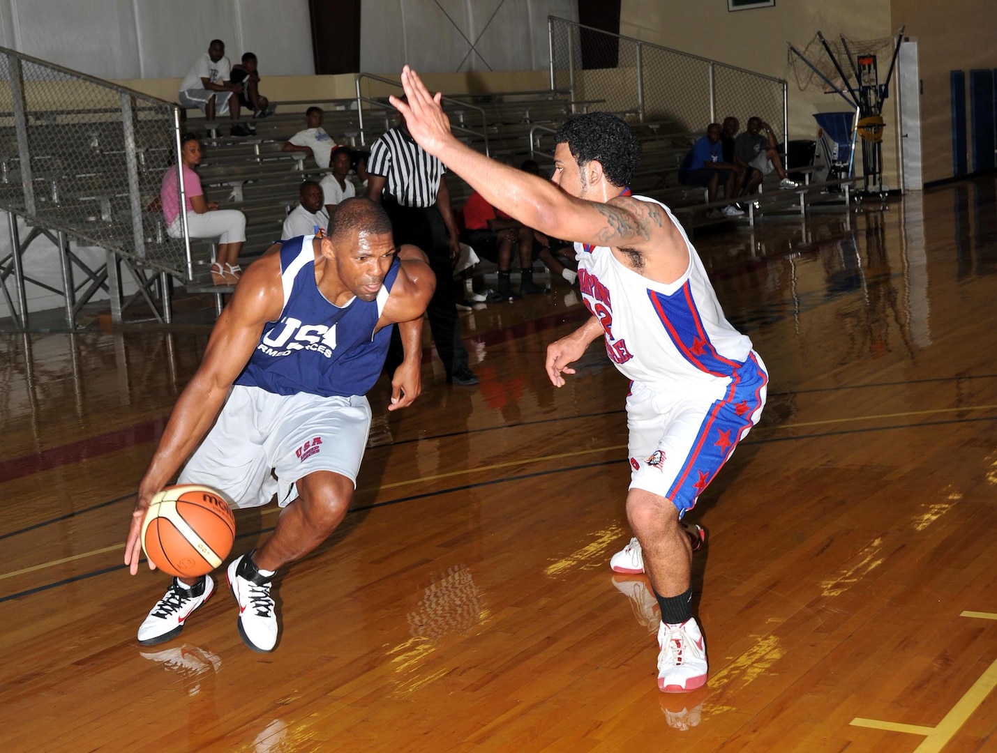 Jammar Major, Hurlburt Field, Fla., looks to beat a Chapparral defender to the baseline. The Armed Forces basketball team scrimmaged semi-professional teams before leaving for the Counseil of International du Sports Militaire's World Military Basketball Championship in Rio, Brazil. (U.S. Air Force photo/Alan Boedeker)