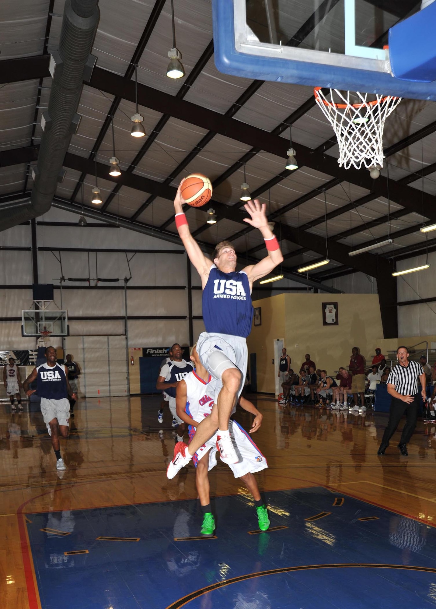 Andrew Henke, Scott Air Force Base, Ill., converts a steal into points against the Chapparrals of San Angelo. The Armed Forces basketball team scrimmaged semi-professional teams before leaving for the Counseil of International du Sports
Militaire's World Military Basketball Championship in Rio, Brazil. (U.S. Air Force photo/Alan Boedeker)