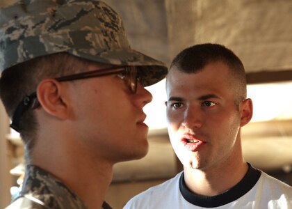 U.S. Air Force Academy Cadet 2nd Class Stephen Savonne, right, corrects a basic military trainee from the 326th Training Squadron June 24. (U.S. Air Force photo/Robbin Cresswell)