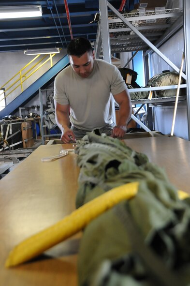 Staff Sgt. Brian Sommers, an aerial porter with 193rd Special Operations Wing, Middletown, Pa. prepared 25-pound parachutes, Jun. 11 to be attached to Container Delivery Systems used for airdrop training.  (Photo by Air Force Tech. Sgt. Culeen Shaffer)