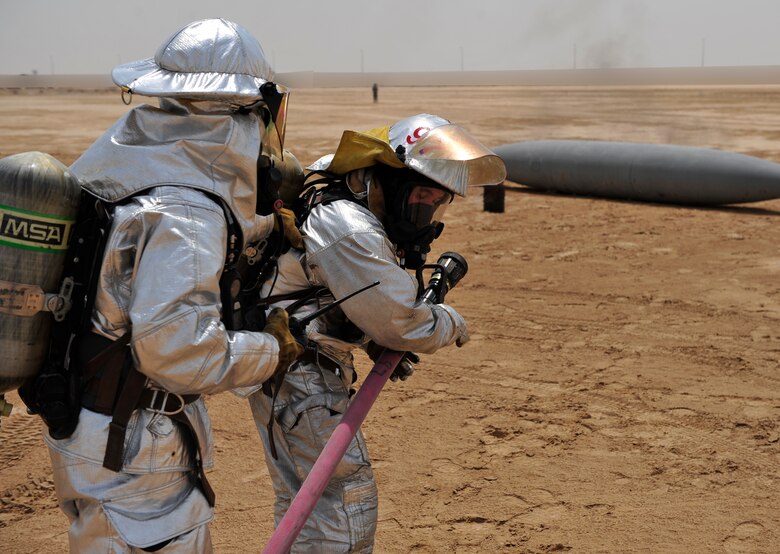 Airmen from the fire department part of the 380th Civil Engineer Squadron participated in a joint training exercise along side the 3rd Battalion, 4th Air Defense Artillery Regiment, July 15, 2011, to learn how to effectively work together during an emergency situation. (U.S. Air Force photo/Staff Sgt. Patrick Mitchell)