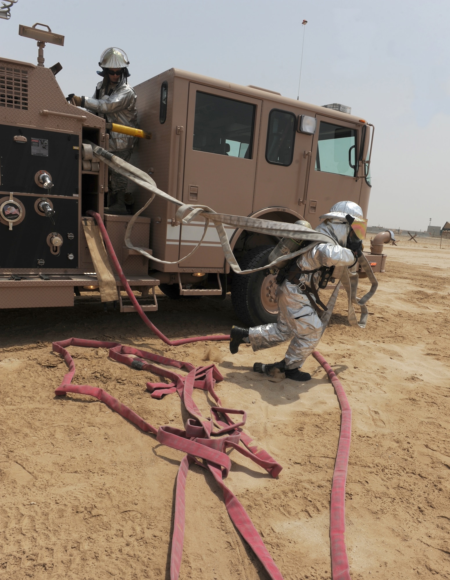 Airmen from the fire department part of the 380th Civil Engineer Squadron participated in a joint training exercise alongside the 3rd Battalion, 4th Air Defense Artillery Regiment, July 15, 2011, to learn how to effectively work together during an emergency situation. (U.S. Air Force photo/Master Sgt. Chance Babin)
