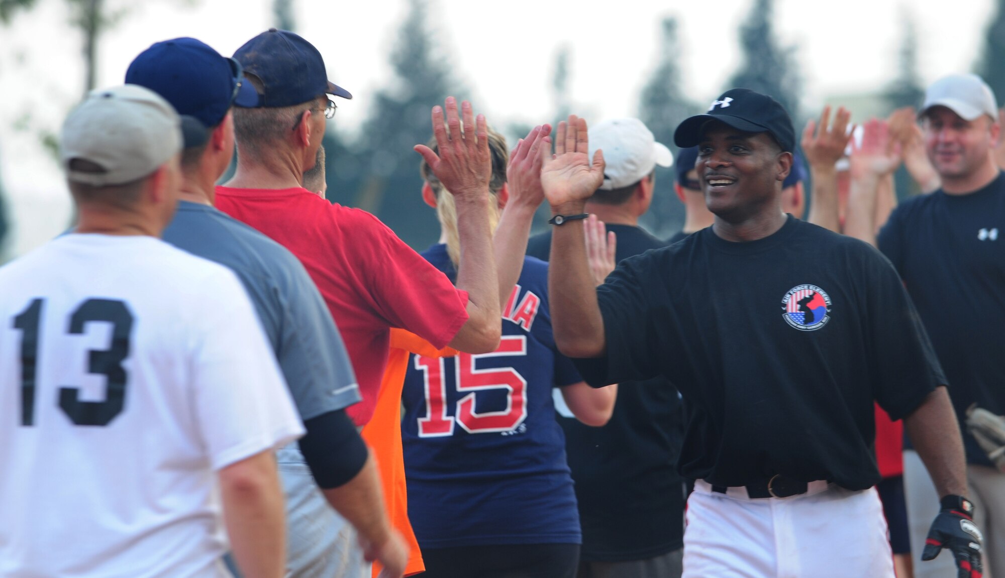 Roderick Dycus, 39th Mission Support Group superintendent, slaps hands with all the softball players during the annual Chiefs vs. Eagles game July 15, 2011, at Incirlik Air Base, Turkey. The Chiefs came out victorious over the Eagles with a 14-8 win. (U.S. Air Force photo by Senior Airman Anthony Sanchelli/Released)
