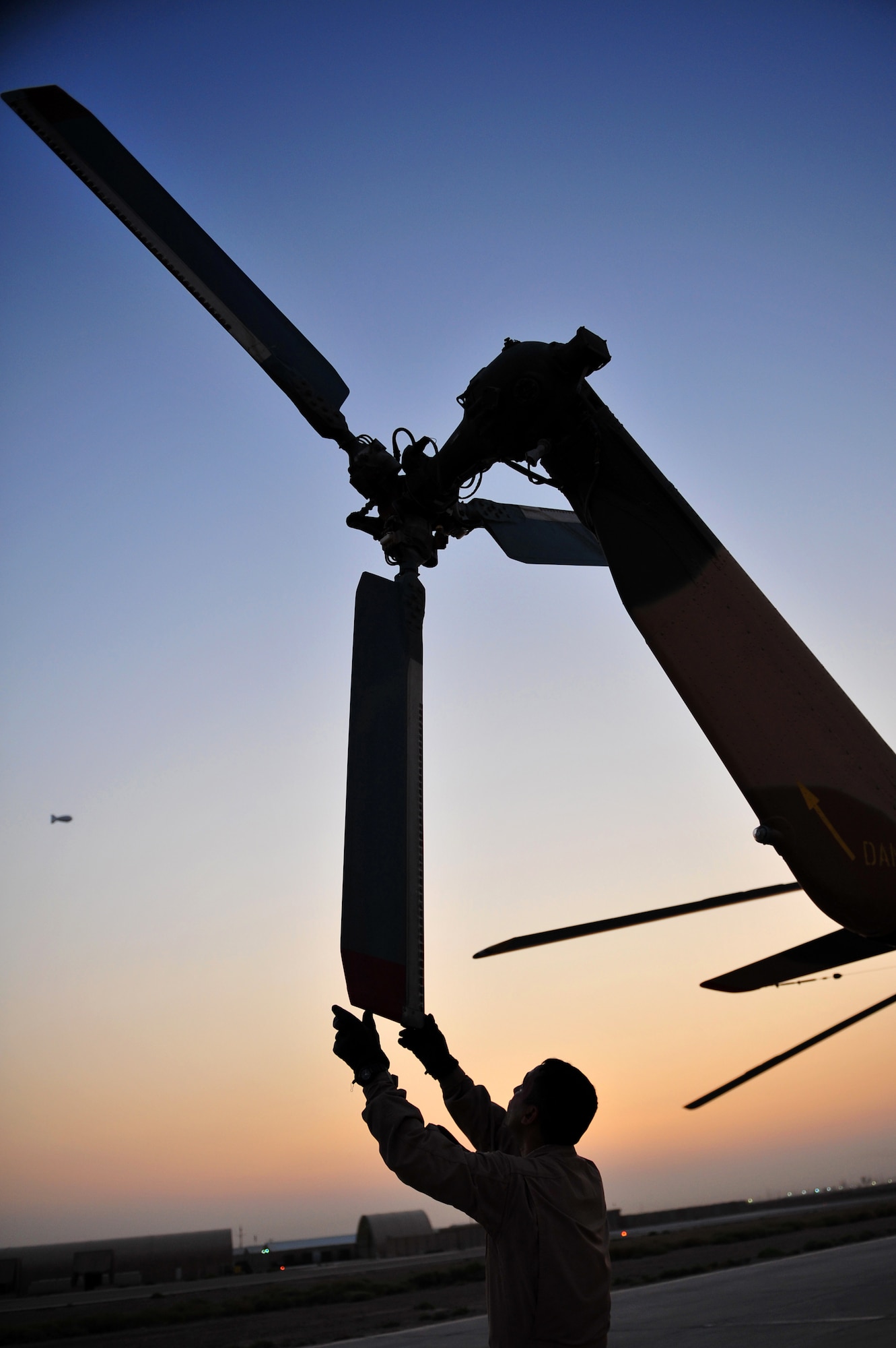 An Iraqi Army Aviation Command, Squadron 15 pilot performs a pre-flight check of a Mi-171 helicopter prior to an upcoming training flight, at Taji Air Base, Iraq, July 11, 2011. Assigned at Taji Air Base, the 721st Air Expeditionary Advisory Squadron trains, advises and assists Iraqi pilots and maintenance personnel, focusing on sustainability, reliability and interoperability. (U.S. Air Force photo/Tech. Sgt. Josef E. Cole III)



