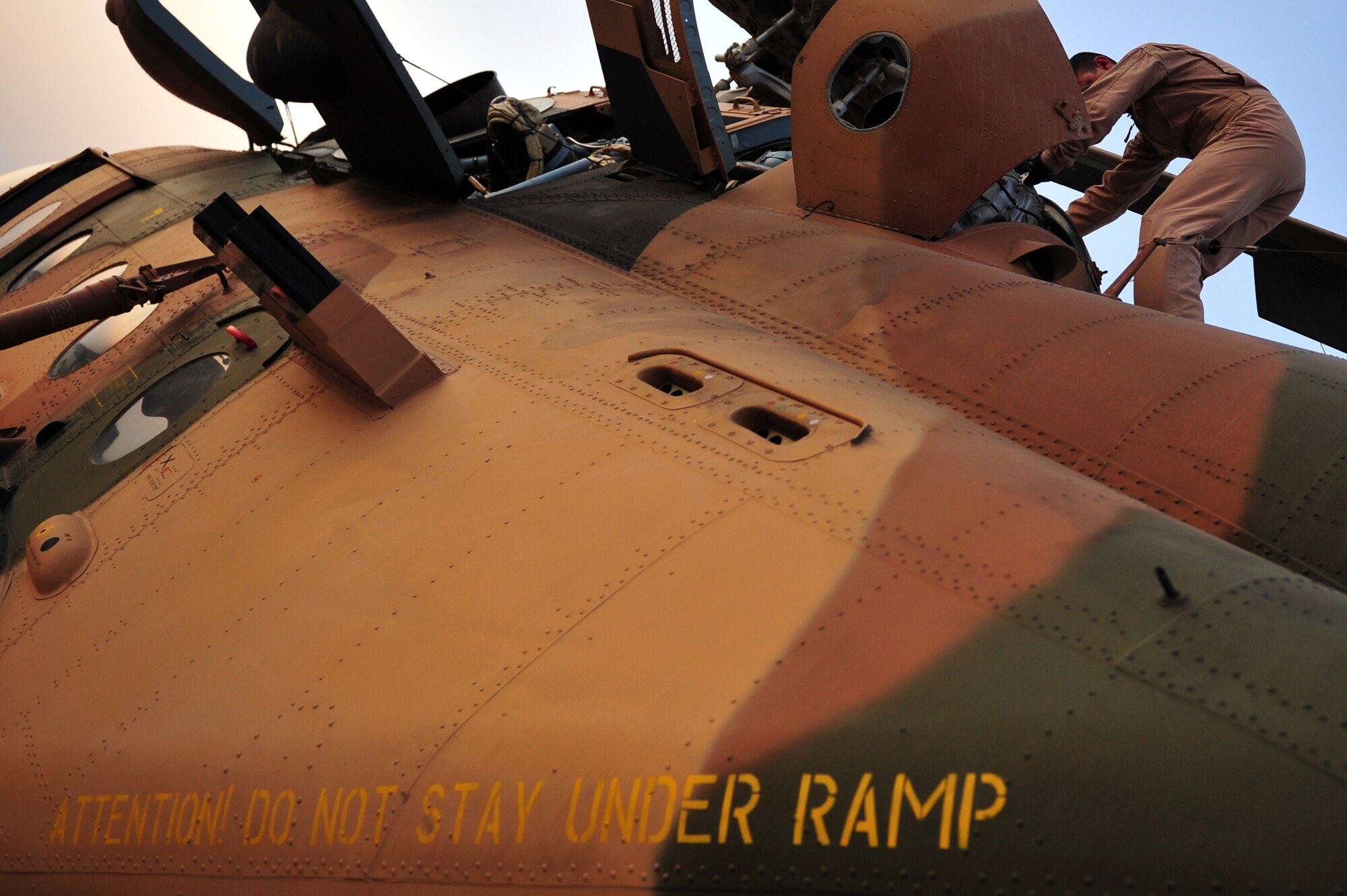 An Iraqi Army Aviation Command, Squadron 15 pilot performs a pre-flight check of a Mi-171 helicopter prior to an upcoming training flight, at Taji Air Base, Iraq, July 11, 2011. Assigned to Taji Air Base, the 721st Air Expeditionary Advisory Squadron trains, advises and assists Iraqi pilots and maintenance personnel, focusing on sustainability, reliability and interoperability. (U.S. Air Force photo/Tech. Sgt. Josef E. Cole III)



