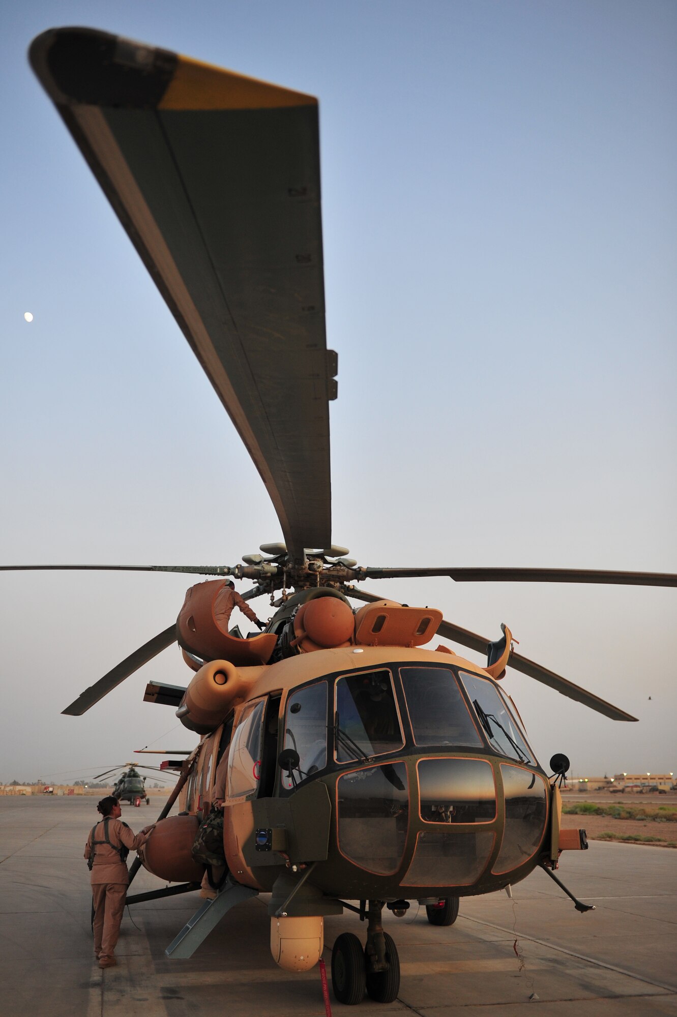 Capt Emily Ladd, 721st Air Expeditionary Advisory Squadron, performs a pre-flight walk around on a MI-171 helicopter prior to a training flight with 21st Squadron, Iraqi Army Aviation Command pilots, at Taji Air Base, Iraq, July 11, 2011. The 721st AEAS trains, advises and assists Iraqi pilots and maintenance personnel, focusing on sustainability, reliability and interoperability. (U.S. Air Force photo by Tech. Sgt. Josef E. Cole III)
