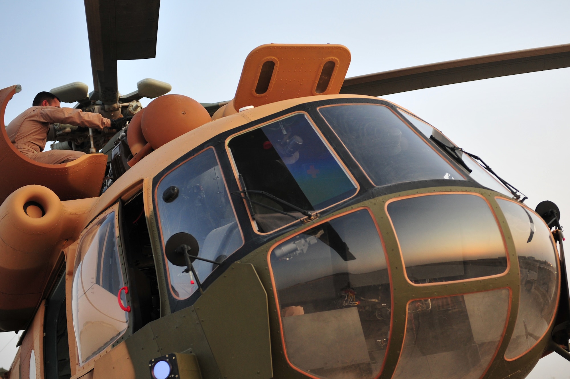 An Iraqi Army Aviation Command, Squadron 15 pilot performs a pre-flight check of a Mi-171 helicopter prior to an upcoming training flight, at Taji Air Base, Iraq, July 11, 2011. Assigned at Taji Air Base, the 721st Air Expeditionary Advisory Squadron trains, advises and assists Iraqi pilots and maintenance personnel, focusing on sustainability, reliability and interoperability. (U.S. Air Force photo/Tech. Sgt. Josef E. Cole III)