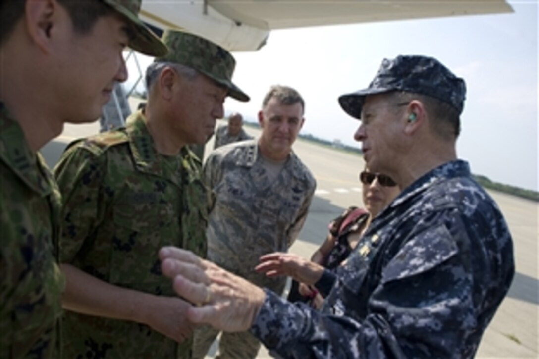 U.S. Navy Adm. Mike Mullen, chairman of the Joint Chiefs of Staff, speaks with Gen. Ryoichi Oriki, chief of staff, Japanese Self-Defense Force, after visiting the devastated region of Sendai, Japan, on July 16, 2011. Sendai was struck by a massive 9.0 earthquake and subsequent tsunami on March 11, 2011 killing over 15, 000 people. 