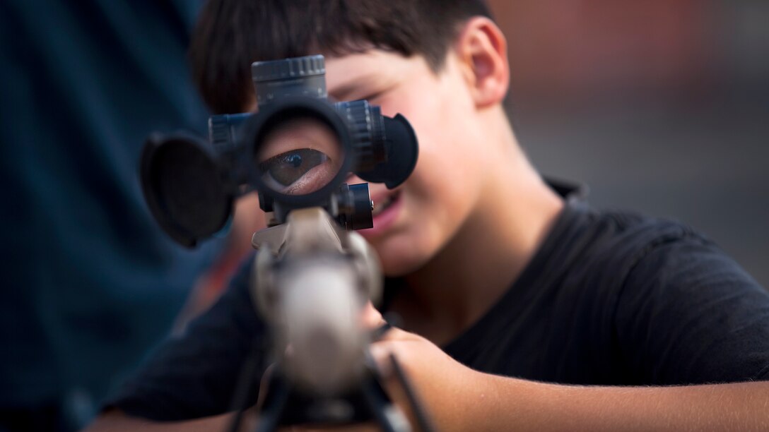 12-year-old Isaac Allsup, from Kailua, Hawaii, stares through the sights of an M40A-series sniper rifle during BayFest 2011 on Marine Corps Base Hawaii, July 16, 2011. Celebrating its 22nd year as Hawaii’s largest summer music festival, the three-day event — sponsored by Marine Corps Community Services — opened the base’s gates to the local community, featuring concerts by Cecilio and Kapono, Hoobastank, Puddle of Mudd and Joe Nichols, in addition to contests, carnival rides, food booths and military static displays.