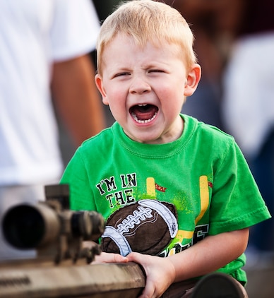 Two-year-old Scott Brown, from Kailua, Hawaii, war cries while holding the butt stock of an M40A-series sniper rifle during BayFest 2011 on Marine Corps Base Hawaii, July 16, 2011. Celebrating its 22nd year as Hawaii’s largest summer music festival, the three-day event — sponsored by Marine Corps Community Services — opened the base’s gates to the local community, featuring concerts by Cecilio and Kapono, Hoobastank, Puddle of Mudd and Joe Nichols, in addition to contests, carnival rides, food booths and military static displays.