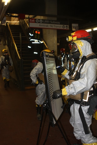 Sgt. Joseph Bates, Sector Team Leader, Extraction Platoon, Initial Response Force B keeps track of Marines and sailors down range in his section as his team pulls victims out of Pennsylvania Station during a joint operation drill with the New York City Fire Department in the early hours of 16 July. The drill was the culmination of the Marine’s week-long training with FDNY. CBIRF and FDNY have worked together for more than 11 years; Deputy Chief Raymond M. Downey, of FDNY’s Special Operations Command, and a former Marine, helped CBIRF develop their technical rescue program before he later died on 9/11 in the World Trade Center towers. (released)