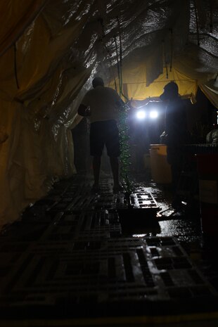 A Marine from Decontamination Platoon, Initial Response Force B instructs a victim how to self decontaminate after walking out of the subways of Pennsylvania Station during a joint operation drill with the New York City Fire Department in the early hours of 16 July. The drill was the culmination of the Marine’s week-long training with FDNY. CBIRF and FDNY have worked together for more than 11 years; Deputy Chief Raymond M. Downey, of FDNY’s Special Operations Command, and a former Marine, helped CBIRF develop their technical rescue program before he later died on 9/11 in the World Trade Center towers. (released)
