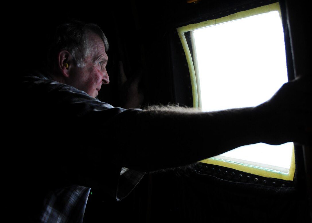 Joseph Golden, a civilian employer, views the sights from aboard a 919th Special Operations Wing MC-130 Combat Talon July 9 during a local area flight near Duke Field, Fla.. Each year, reservists from the 919th Special Operations Wing are encouraged to invite their employers to Employer Appreciation Day, an event aimed at praising their support and informing and educating them on the vital roles their reservist "Citizen Commandos" play in national defense.  Employers received a mission briefing from the wing's commander and toured several squadron work centers before taking the flight. (U.S. Air Force photo/Tech. Sgt. Cheryl Foster)