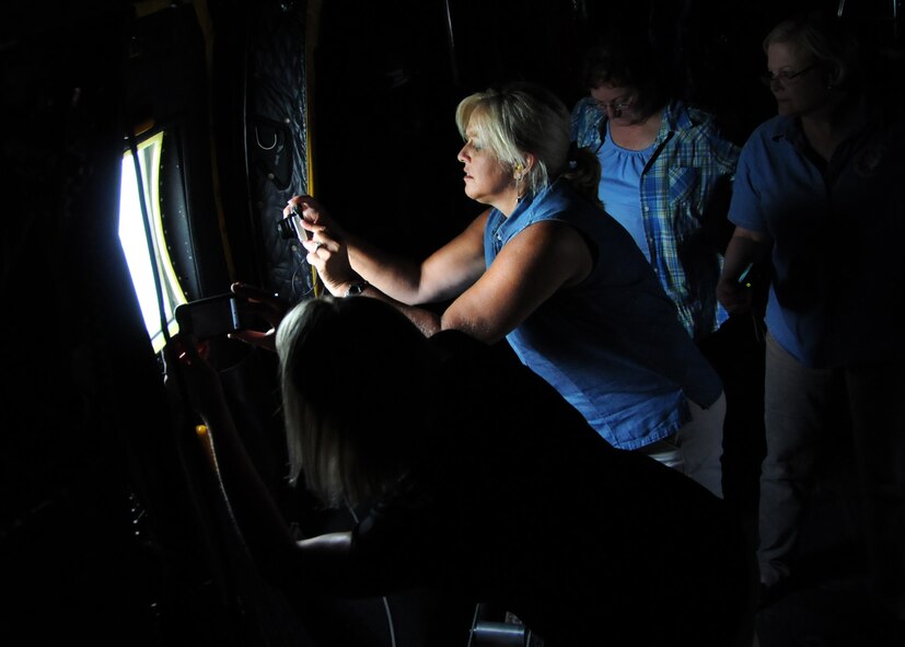 Civilian employers take turns photographing the sights from aboard a 919th Special Operations WIng MC-130 Combat Talon during a local area flight July 9 near Duke Field, Fla.. Each year, reservists from the 919th Special Operations Wing are encouraged to invite their employers to Employer Appreciation Day, an event aimed at praising their support and informing and educating them on the vital roles their reservist "Citizen Commandos" play in national defense.  Employers received a mission briefing from the wing's commander and toured several squadron work centers before taking the flight. (U.S. Air Force photo/Tech. Sgt. Cheryl Foster)