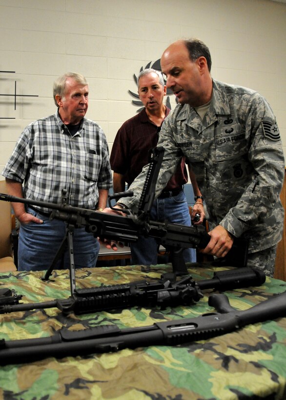 Air Force Reserve Tech. Sgt. Wade Bowser of the 919th Security Forces Squadron displays an M-249 combat machine gun for visiting civilian employers touring Duke Field July 9.   Each year, reservists from the 919th Special Operations Wing are encouraged to invite their employers to Employer Appreciation Day, an event aimed at praising their support and informing and educating them on the vital roles their reservist "Citizen Commandos" play in national defense.  Employers received a mission briefing from the wing's commander, toured several squadron work centers and took a local area flight aboard one of the wing's MC-130E Combat Talon aircraft. (U.S. Air Force photo/Tech. Sgt. Cheryl Foster)
