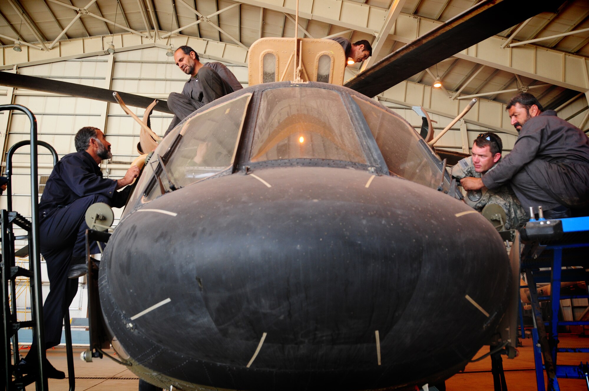 Afghan Air Force maintainers perform routine maintenance on a AAF Mi-17 helicopter in the maintenance hangar on the AAF compound in Kabul, Afghanistan. Although Afghans have been flying and training in the aircraft for the last 30 years, the Airmen and coalition partners continue to familiarize the AAF on the intricacies of maintenance requirements of the helicopter in order to prepare them for future battlefield mobility.  (U.S. Air Force photo by Senior Airman Amber Williams)