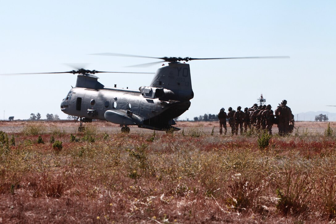 Marines with 11th Marine Expeditionary Unit's maritime raid force board a CH-46 Sea Knight for transportation during an exercise here July 17. The MRF, along with a section of the unit's aviation combat element, Marine Medium Helicopter Squadron 268 (Reinforced), and command element, are taking part in a large-scale exercise with ocean and urban-based scenarios.