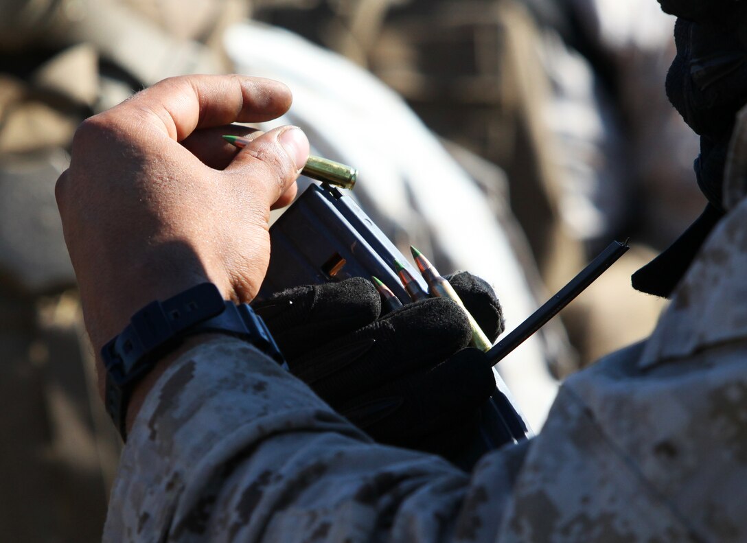 FIRE BASE SAENS, Helmand province, Afghanistan—Smoke blasts from the muzzle break of the M777 A2 Howitzer as a satellite-guided Excalibur XM982 Precision Engagement Projectile makes its way down range to support a collation force calling for fire.  Alpha Battery, 1st Battalion, 12th Marines is one of the busiest batteries in Afghanistan as they provide 24-hour a day, 7-day a week support to any unit within range of their guns. (Official Marine Corps Photo by Sgt. Earnest J. Barnes)