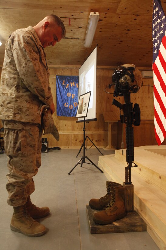 Brig. Gen. Glenn M. Walters, the commanding general of 2nd Marine Aircraft Wing (Forward), pays his respects during a memorial ceremony honoring the life and service of Staff Sgt. Thomas J. Dudley, July 18. Dudley fell to his death from an MV-22 Osprey while conducting combat operations in southwestern Afghanistan, July 7. “He’ll be missed dearly but he will be with us forever,” said Gunnery Sgt. Shawn A. Howard, the quality assurance chief for Marine Medium Tiltrotor Squadron 264, and a native of Brooksville, Fla. “This was not just a loss for the squadron, his family and friends, but for the Marine Corps as a whole.”