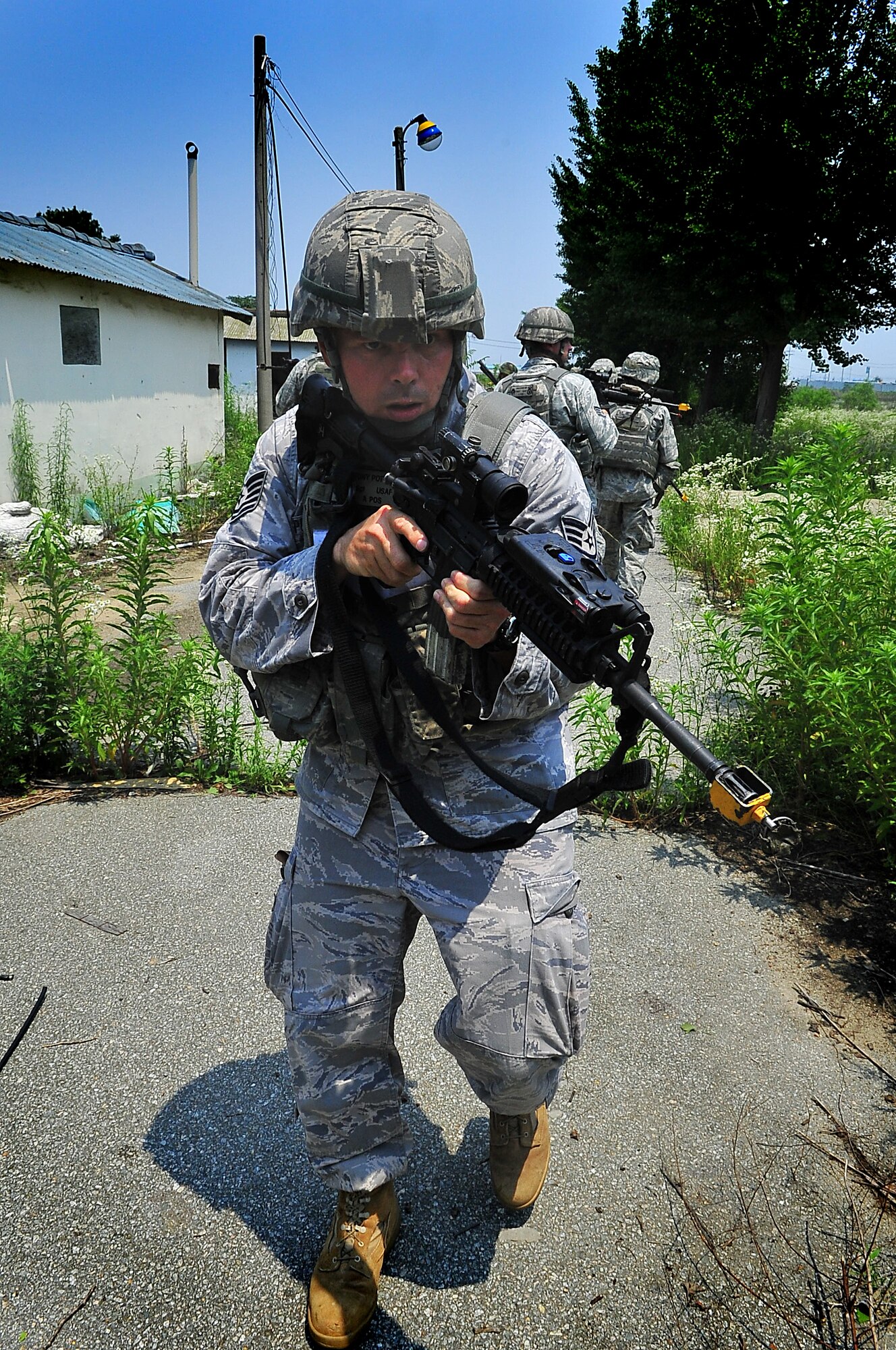 51st Security Forces Squadron and Republic of Korea Air Force members performed base defense operations training during the combat readiness course at Osan Air Base, June 26. During training, combined SF members' reacted to [simulated] hostile forces. Members were challenged with securing Base Alpha, executing troop movement maneuvers and communication tactics. Security Forces members are responsible for ensuring the safety of bases, weapons, property and personnel from hostile forces. (U.S Air Force Photo by/Staff Sgt. Daylena Gonzalez)