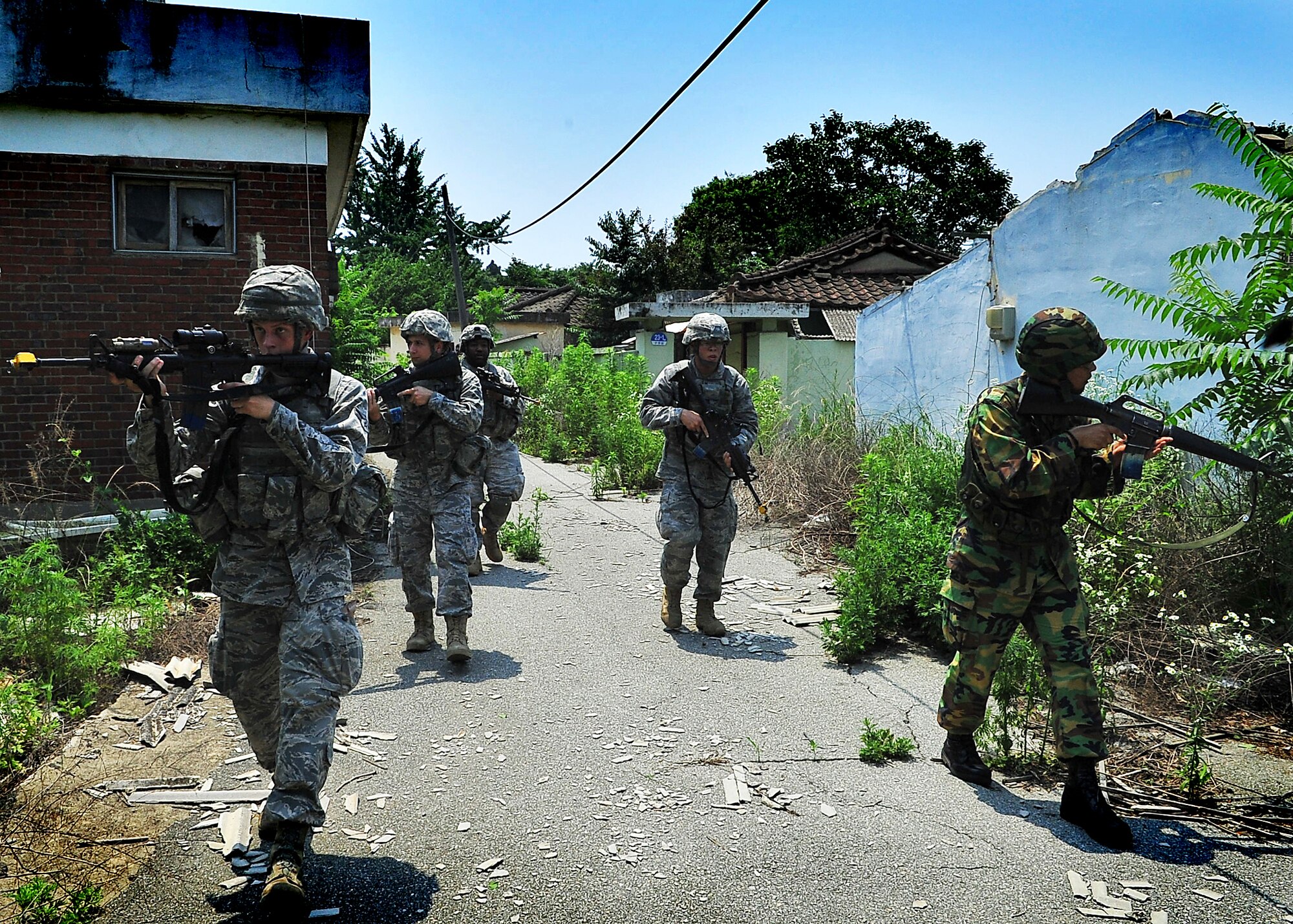 51st Security Forces Squadron and Republic of Korea Air Force members performed base defense operations training during the combat readiness course at Osan Air Base, June 26. During training, combined SF members' reacted to [simulated] hostile forces. Members were challenged with securing Base Alpha, executing troop movement maneuvers and communication tactics. Security Forces members are responsible for ensuring the safety of bases, weapons, property and personnel from hostile forces. (U.S Air Force Photo by/Staff Sgt. Daylena Gonzalez)