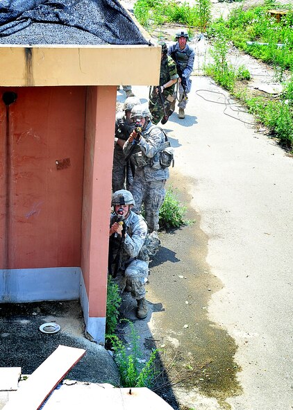 51st Security Forces Squadron and Republic of Korea Air Force members performed base defense operations training during the combat readiness course at Osan Air Base, June 26. During training, combined SF members' reacted to [simulated] hostile forces. Members were challenged with securing Base Alpha, executing troop movement maneuvers and communication tactics. Security Forces members are responsible for ensuring the safety of bases, weapons, property and personnel from hostile forces. (U.S Air Force Photo by/Staff Sgt. Daylena Gonzalez)